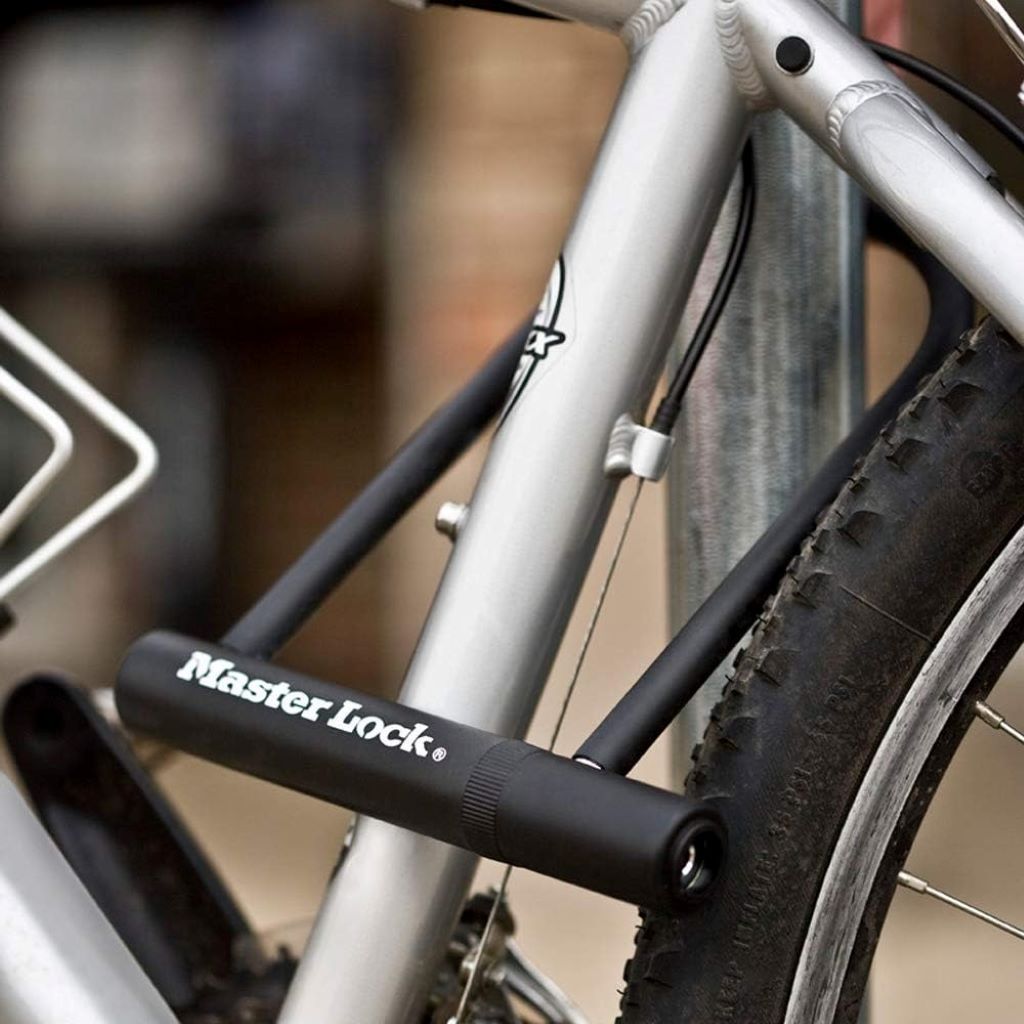 Close-up of Master Lock U-lock attached to bike rack, featured in expert review of durable keyed bike locks.