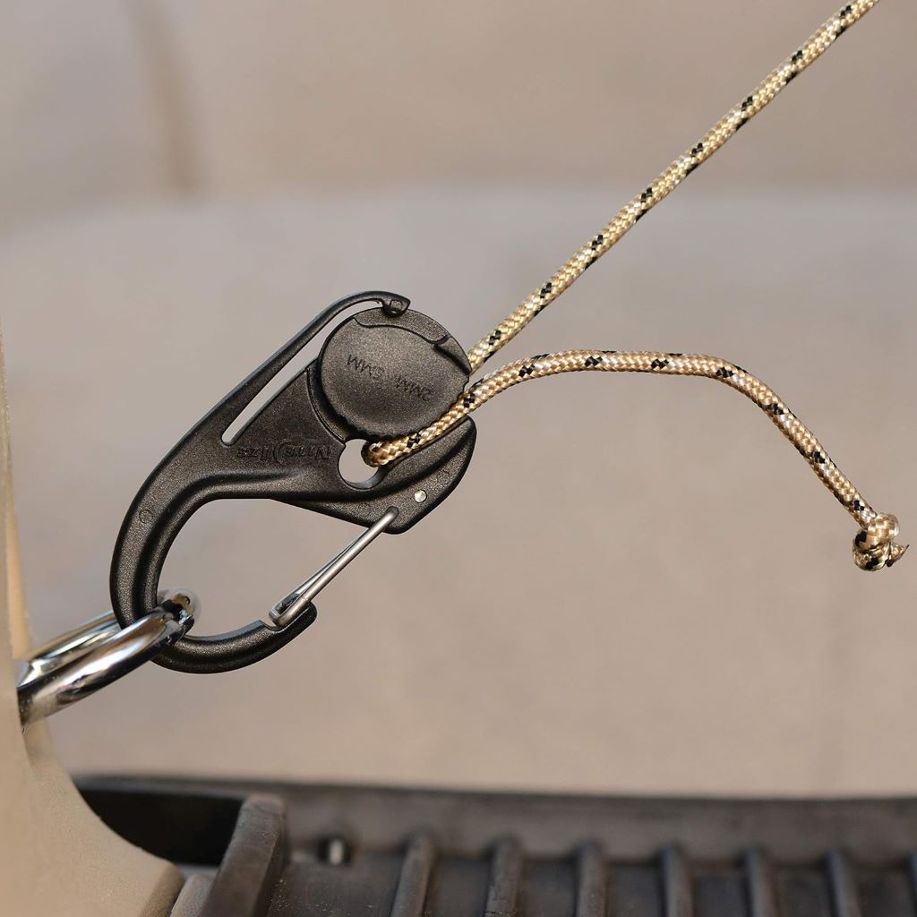Close-up of Nite Ize CamJam 2-pack in black; compact rope tighteners with carabiner clips locking cords in place—popular for camping, bundling, and lightweight cargo setups.