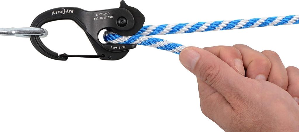 Nite Ize CamJam XT Large Aluminum Rope Tightener in black, ideal for securing gear during hiking or camping.