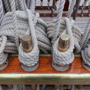 Close-up of thick, durable marine ropes coiled on a dock, highlighting strength and nautical use