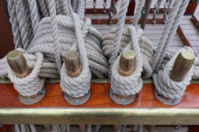 Close-up of thick, durable marine ropes coiled on a dock, highlighting strength and nautical use
