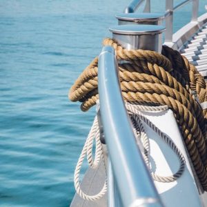 Close-up of traditional hemp rope alongside modern synthetic marine rope on a ship deck, symbolizing the evolution of nautical rope technology