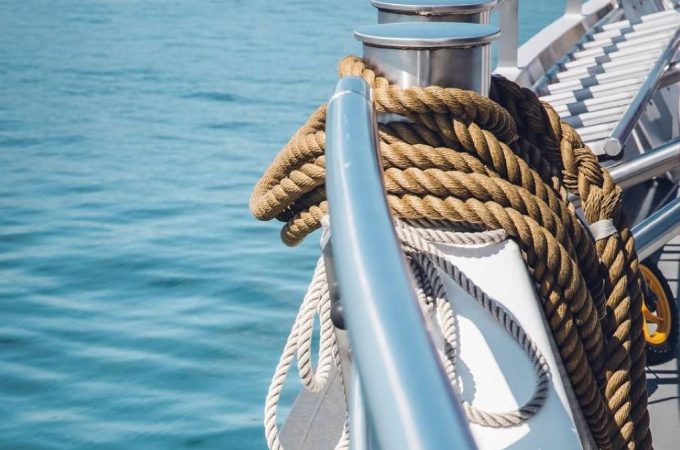 Close-up of traditional hemp rope alongside modern synthetic marine rope on a ship deck, symbolizing the evolution of nautical rope technology