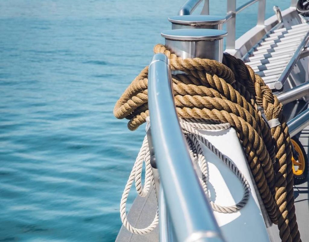 Close-up of traditional hemp rope alongside modern synthetic marine rope on a ship deck, symbolizing the evolution of nautical rope technology