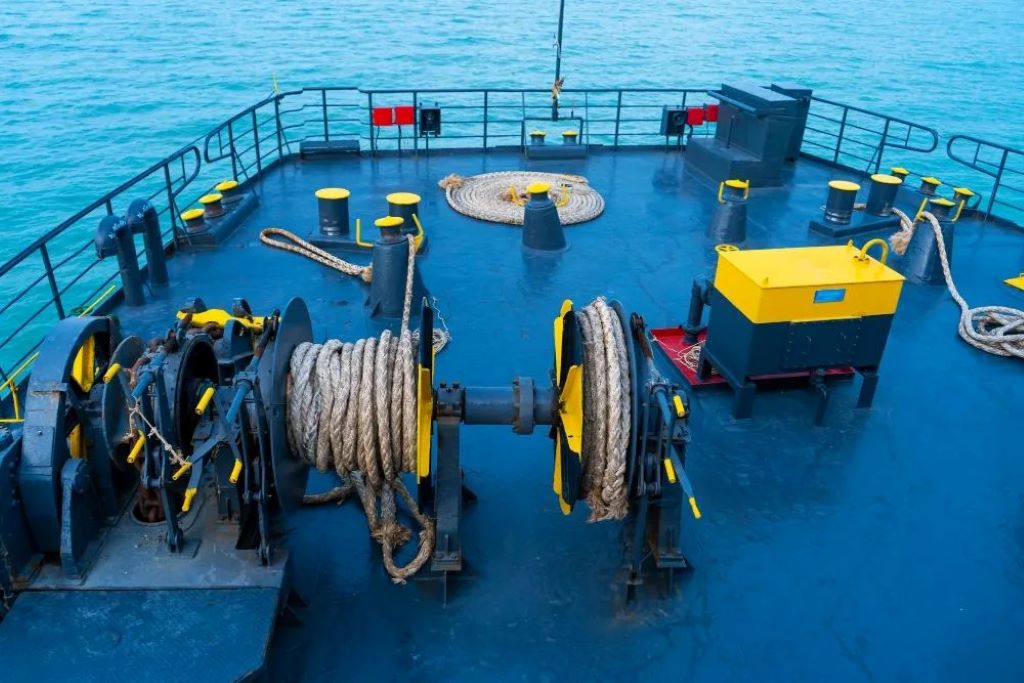 A large cargo ship securely moored to a dock with thick marine ropes demonstrating the strength and reliability of ship ropes
