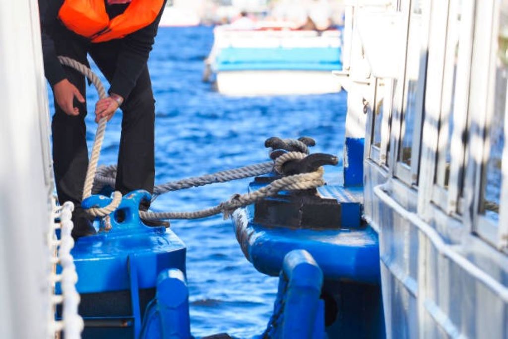 Close-up of heavy-duty mooring ropes tied to a ship bollard, showing how ships rely on rope for stability and safety