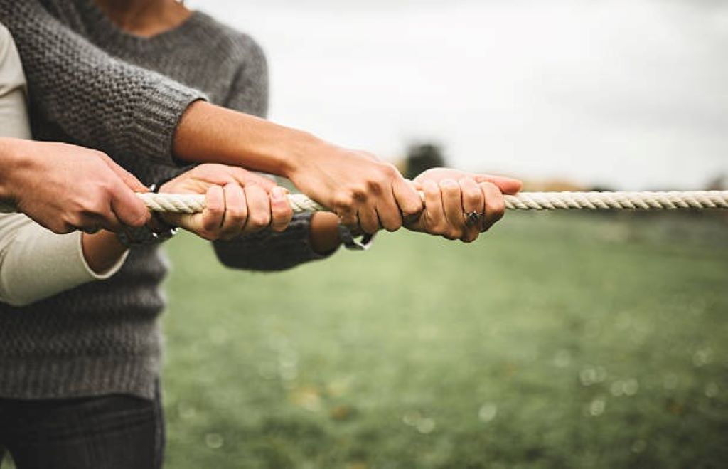 Close-up of a person handling a snapback rope, highlighting the dangers of improper pulling techniques