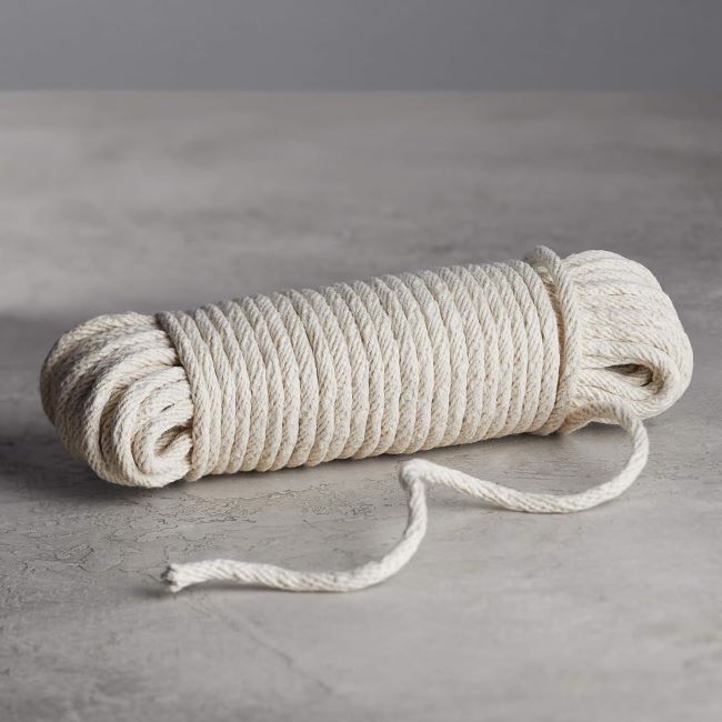 Durable off-white cotton rope for versatile use in clotheslines, crafting, and home projects.