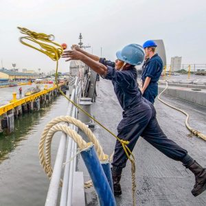 Close-up of a mooring rope with protective care tools on deck.