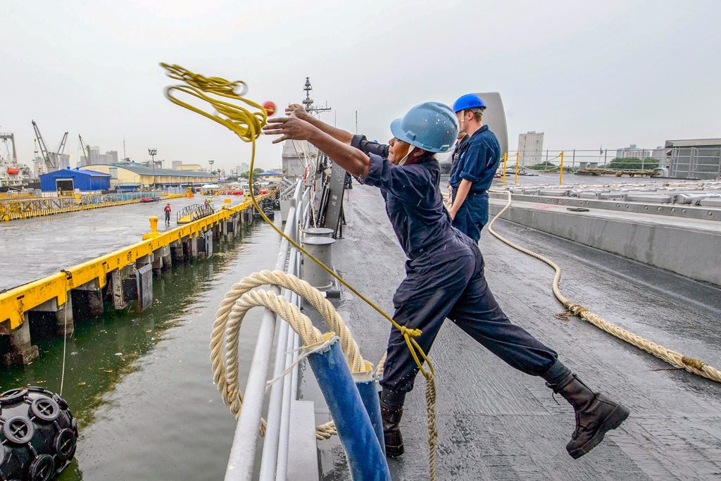 Close-up of a mooring rope with protective care tools on deck.