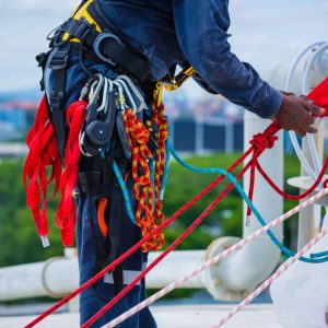 Seafarer inspecting a rope to prevent accidents through regular maintenance.