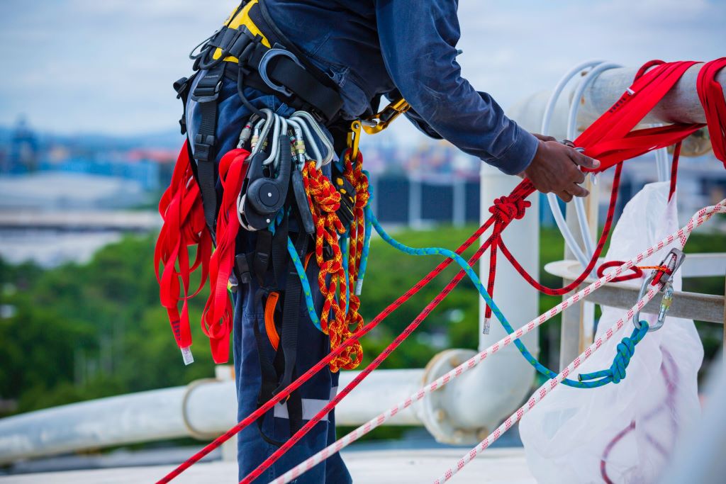Seafarer inspecting a rope to prevent accidents through regular maintenance.