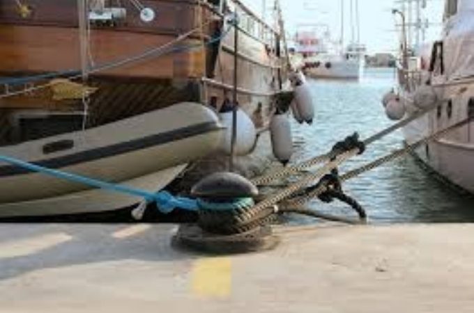 Trawler crew inspecting and maintaining ropes to prevent gear failure at sea.