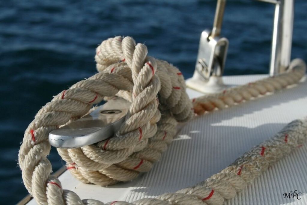 Fisherman performing rope maintenance on a trawler to ensure safe operations.