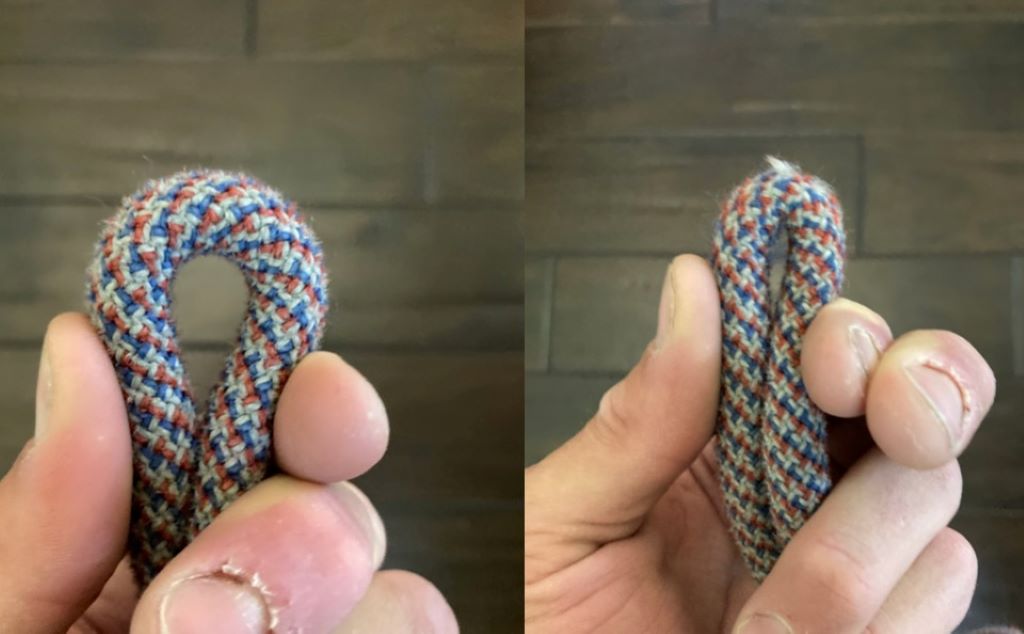 Technician bending and inspecting a rope to detect unseen wear.