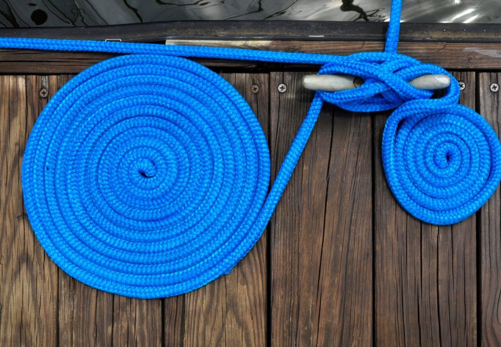 Seafarer inspecting a rope to ensure longevity and safety.