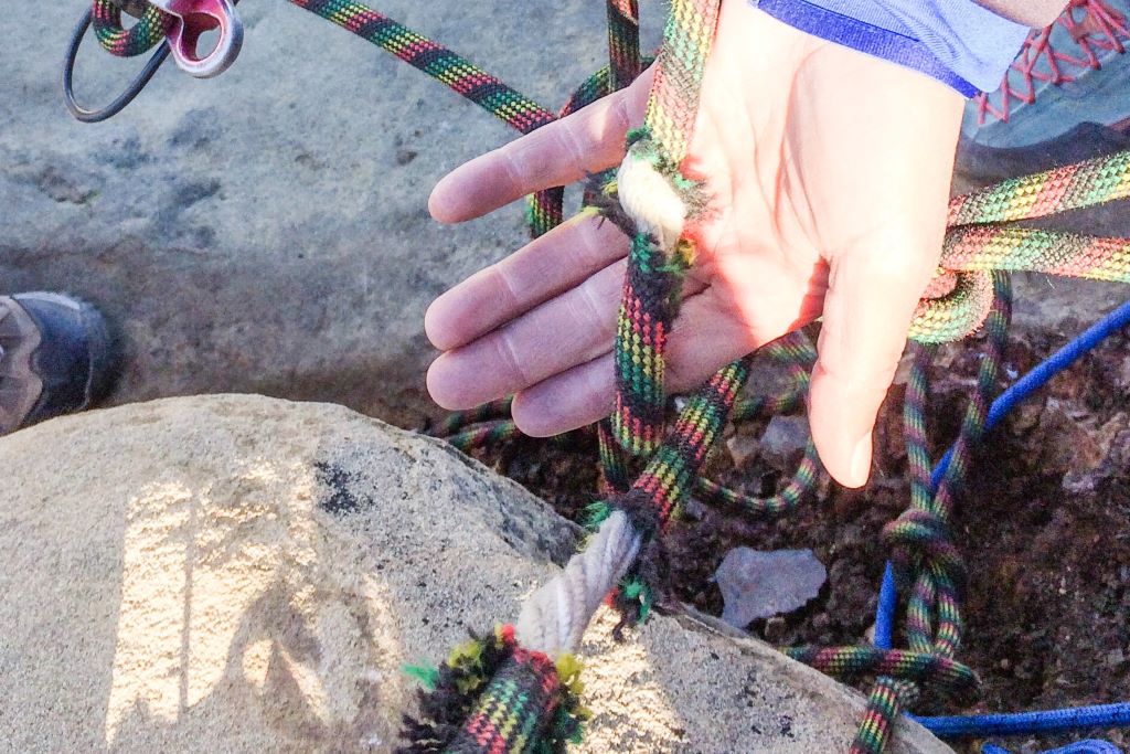 Seafarer examining a broken rope caused by neglect and wear.