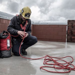 Close-up of hands cleaning and checking a rope for wear and tear.