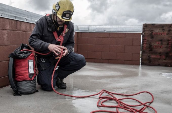 Close-up of hands cleaning and checking a rope for wear and tear.