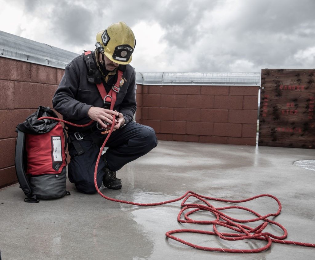 Close-up of hands cleaning and checking a rope for wear and tear.