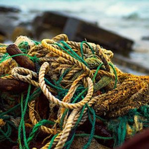 Saltwater corroding a rope on a boat, showing wear and fraying.