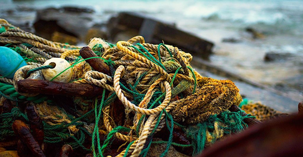 Saltwater corroding a rope on a boat, showing wear and fraying.