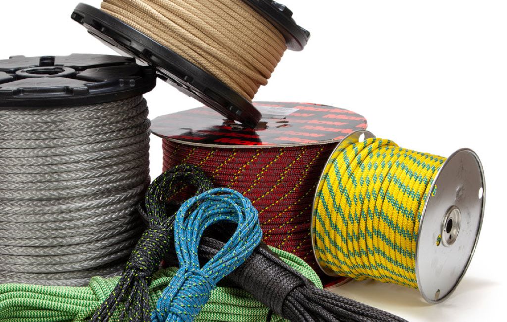 Worker selecting synthetic rope for industrial or off-road heavy-duty applications