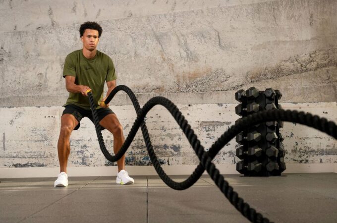 Person performing alternating wave battle rope workout for fitness and endurance
