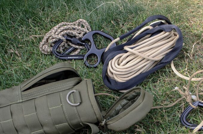 Camper using a multi-purpose rope to secure a tent during an outdoor camping trip