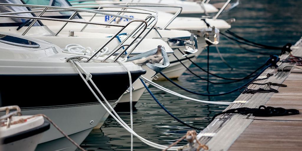 Boat secured at a dock using strong mooring lines for safe anchoring in calm water